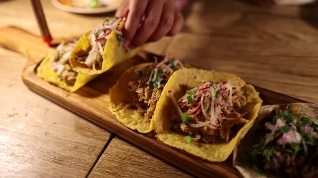 Hands Sharing Grilled Tacos on Wooden Table in Bangkok