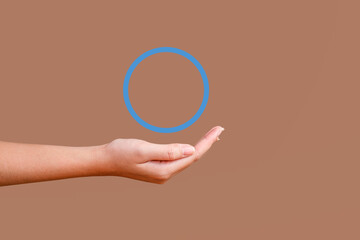 Outstretched Woman Hand Under A Floating Blue Circle Symbol Diabetes On Brown Background.