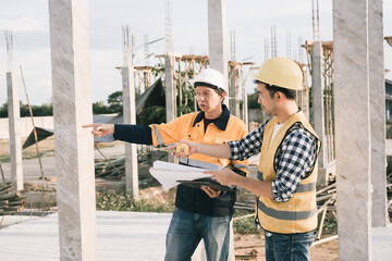 Male and female engineers who are Asian professionals in the construction industry focus on village...
