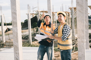 Male and female engineers who are Asian professionals in the construction industry focus on village...
