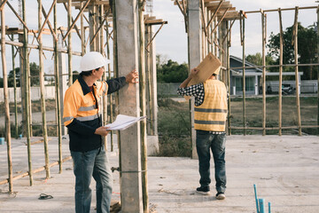 Male and female engineers who are Asian professionals in the construction industry focus on village...