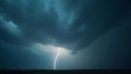 A dramatic lightning strike illuminates the dark sky during a powerful thunderstorm over a field landscape