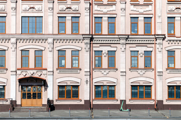 building symmetry square shape background facade wall windows and entrance door pedestrian street...