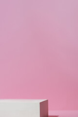 Geometric white scene on a pink background. A premium podium for advertising and presentation of your product. Showcase, display case.
