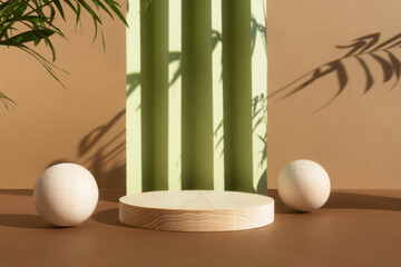 Wooden podium on an abstract green and beige background with the shadow of palm leaves. Empty scene with a geometric backdrop for the product presentation. Showcase for natural eco cosmetic.