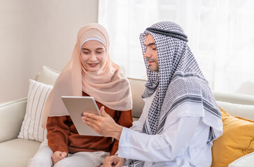 young muslim arabic couple using tablet together in the living room
