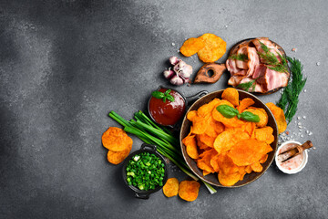 Potato chips with bacon in a ceramic bowl. Salty snacks for beer.