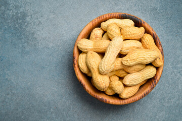Wooden bowl with peanuts in the shell. Nuts Close-up.