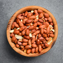 Shelled peanuts in a wooden bowl. Nuts close-up