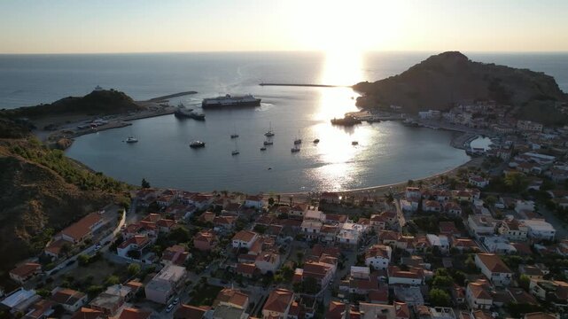 Myrina Port and City Center Aerial Panoramic View, Ferry Arrives in Limnos Greece, Backlit Shot, Afternoon Lighting