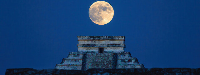 Dramatic full moon rising over ancient Mayan pyramid ruins creating mystical ambiance and travel allure