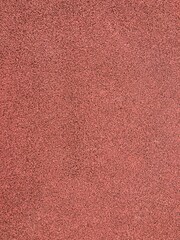 Running Track Texture, This image shows a uniformly textured surface, likely a running track, with small, reddish-brown particles creating a consistent, slightly rough appearance.