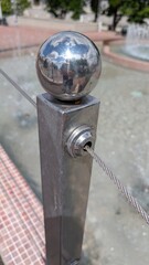 This is a modern stainless steel barrier that features a striking reflective ball design