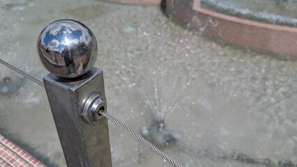 A CloseUp of a Beautiful Fountain Showcasing Stunning Reflections and Various Water Features