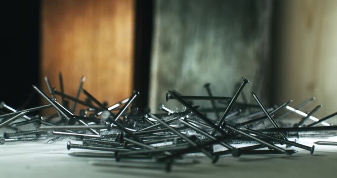 umping Steel Nails in Slow Motion. Shot of Metal Nails Bouncing and Scattering on White Surface, Capturing Energy, Impact, and Industrial Vibration in High Detail at 1000 fps