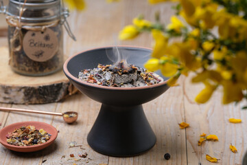 Top view of Beltane incense ritual with frankincense, resins and dried herbs