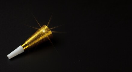 Gold glitter glue tube on black background with sparkles  