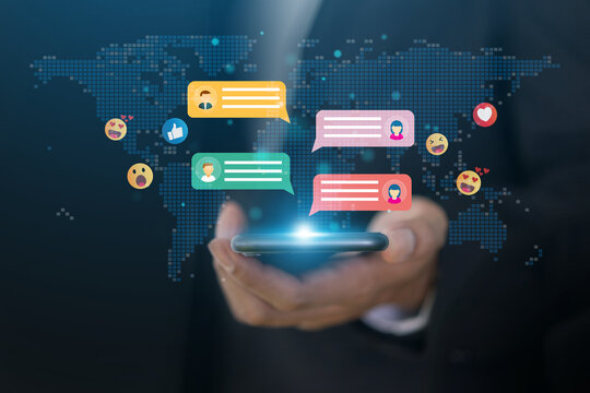 Human hand using smartphone typing Live chat chatting and social network concepts, chatting conversation working at home in chat box icons pop up. Social media marketing technology concept