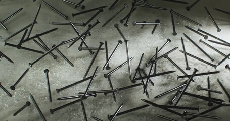 Jumping Steel Nails on Impact in Slow Motion  Close-Up of Metal Nails Bouncing and Scattering on a Hard Surface with Particles Flying, Capturing Industrial Energy and Chaotic Motion at 1000 fps. - Powered by Adobe
