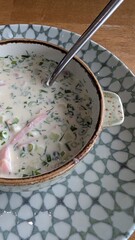 Savor the Delicious Creamy Soup that features Chopped Herbs and an assortment of Vegetables
