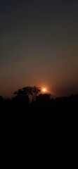 Fototapeta premium A beautiful orange sunset paints the mountain landscape and evening sky