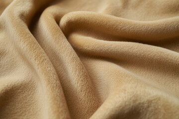 Soft beige fleece material cascades gently, creating a beautiful display of rich textures, warm comfort, and inviting wavy folds.