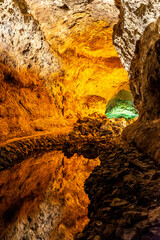 Cueva de los Verdes &ndash; Illuminated volcanic lava tube on the Canary Island of Lanzarote with a perfect reflection in a natural lagoon