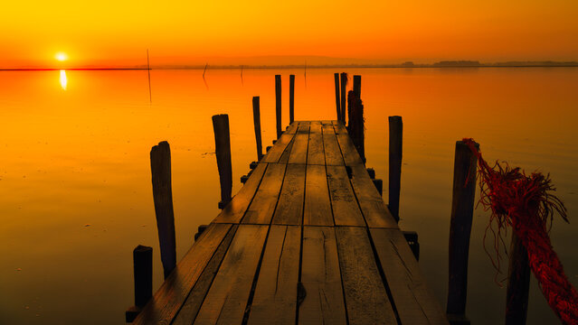 Ria da Aveiro, Portugal: Old fishing pier at sunset in a calm atmosphere, minimalism concept
