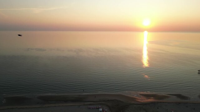 Ocean Sunset: Witness a serene seascape where the sun dips below the horizon, painting the ocean and sky with vibrant colors. A peaceful panorama to evoke tranquility. Rimini, Emilia-Romagna