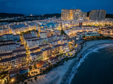 Aerial view of golden lights illuminate the coastal buildings and shoreline in a vibrant display of urban life, Phu Quoc, Kien Giang, Vietnam.