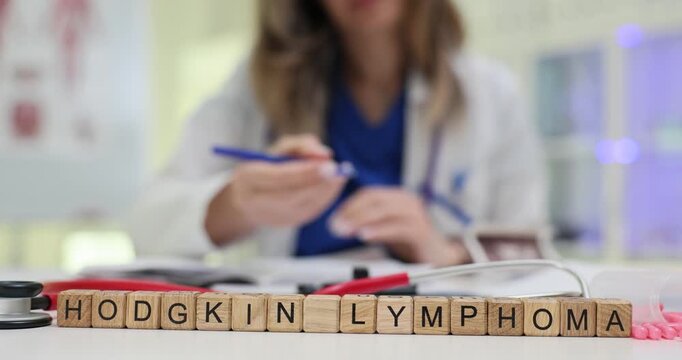 Hodgkin Lymphoma word stands on wooden blocks emphasizing oncology research. Doctor at back reviews papers creating diagnosis analysis atmosphere