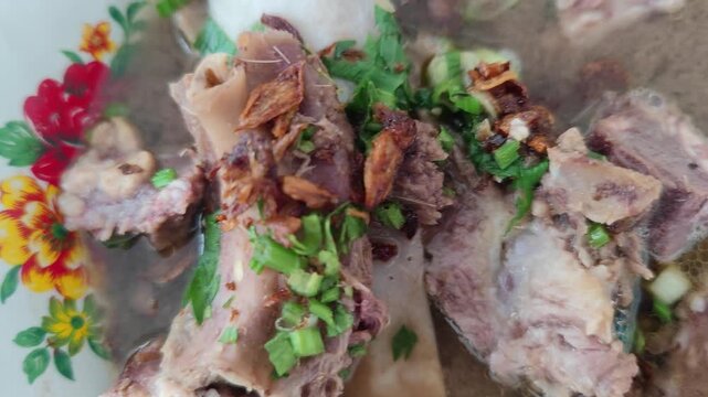 A rich and flavorful video of Konro, a traditional beef rib soup from Makassar, South Sulawesi, Indonesia. Made with tender beef ribs simmered in a dark, aromatic broth, this dish features local spice