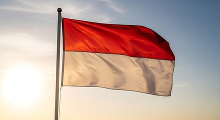 Vibrant Indonesian Flag Waving Proudly Against Golden Sky at Sunrise