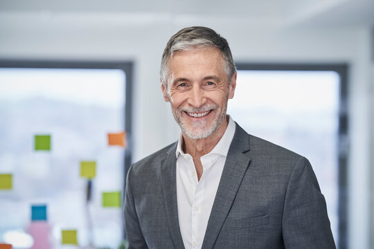 Happy senior businessman in office