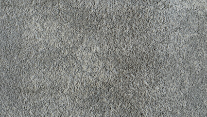 Fototapeta premium Abstract grey textured background showing a rough grainy surface. Excellent for minimalist designs, backdrops or to add subtle depth.