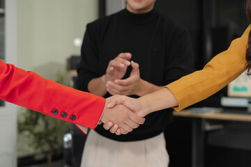 Businessmen shake hands after agreeing to start a new project successfully.