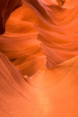 This image shows the inside of Antelope Canyon, a slot canyon in the American Southwest, known for its wave-like rock formations and vibrant orange colors, formed by erosion over millions of years.