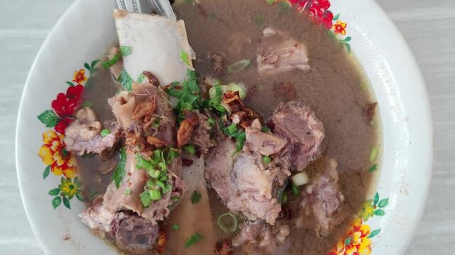 A rich and flavorful video of Konro, a traditional beef rib soup from Makassar, South Sulawesi, Indonesia. Made with tender beef ribs simmered in a dark, aromatic broth, this dish features local spice