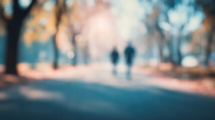 Blurred Of Autumn Park Background With Silhouetted Couple Walking Along a Sunny Pathway Perfect for Website Banner Use or Poster Design