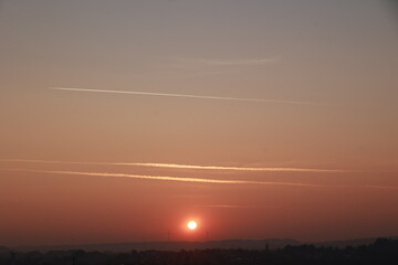 The sky is a beautiful orange color with a sun in the middle