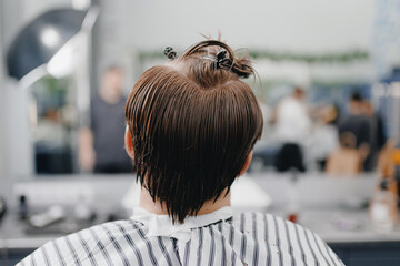 Back view men haircut transformation at modern barbershop hair salon