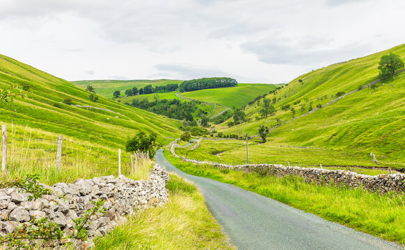 Yorkshire Dales in Summertime.  A single track, winding road leading from Kettlewell in Wharfedale over moorland and into Coverdale, North Yorkshire, UK. Horizontal  Copy space