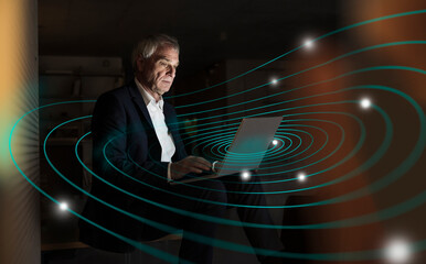 Digital composite image of senior businessman using laptop with futuristic network