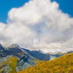 mountain valley in snow under dense cloudy sky