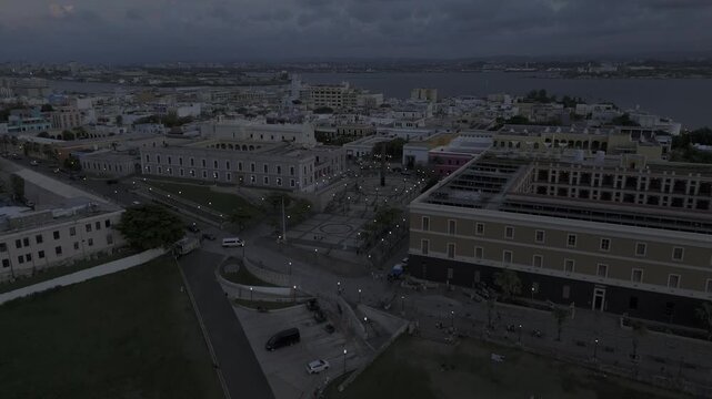 Drone flies toward Plaza del Quinto Centenario after sunset in historic city center in San Juan, Puerto Rico