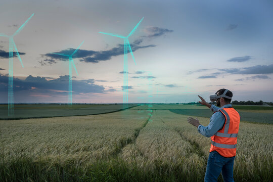Engineer looking at digital wind turbine models in field