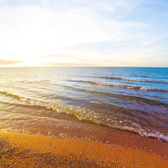 sandy sea beach at the dramatic sunset