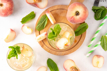 Flat chinese peach and lime lemonade, mojito cocktail