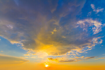 dramatic sunset on dense cloudy sky background