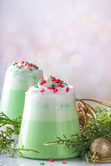 Green matcha Christmas latte with whipped cream